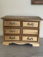 Front view showing six drawers and missing pull