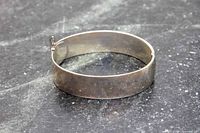 Front view of wide sterling silver bangle showing plain exterior surface