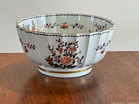 Side view of bowl showing exterior floral pattern and scalloped panels