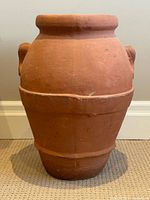 Front view of terracotta urn showing handles and overall form