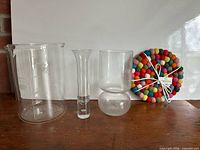 Group shot of jug, two vases, felted wool trivet