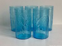 Group shot of five blue Flora tumblers standing