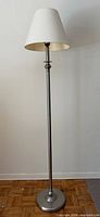 Full view of chrome floor lamp with shade