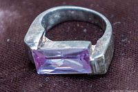 Top view showing purple rectangular gemstone set across sterling band
