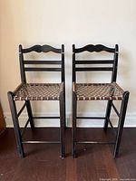 Pair of black ladder back bar stools front view