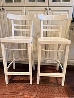 Front view of both white counter stools