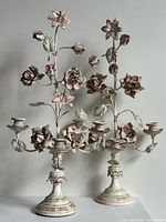 Both candelabras front view showing floral details and bases