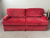 Front view of red velvet damask sofa
