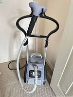 Front view of full Rowenta IS9100 steamer showing hanger frame, hose and base