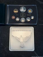 1999 proof set open beside closed metal keepsake case