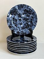 Stack of eight Marble Blue charger plates showing pattern and quantity