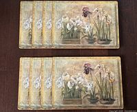 All eight placemats arranged in two stacks showing quantity and overall condition