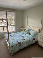 Full view of assembled ivory four-poster bed in room
