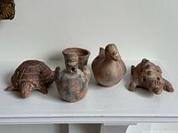 Front view of all four terracotta animal effigy whistles