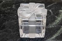 Closed crystal box showing frosted ribbon and bow detail