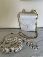 Both evening bags shown together on marble surface