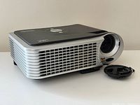 Angled view of projector with lens cap detached
