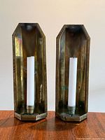 Front view of both brass wall sconces with candles inserted