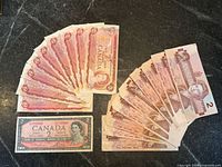 All 19 notes fanned out showing fronts of each series