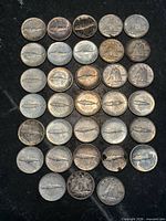 All 33 Canadian silver dimes laid out on black background