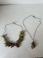 Overview of both corded pendant pieces