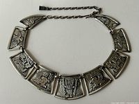 Full view of Coro silver-tone Aztec collar necklace laid flat showing seven panels and extender chain