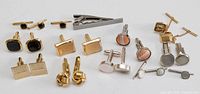 Group shot of all cufflinks, studs, tie clip and tie tack