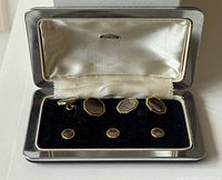 Open case showing full set of cufflinks and studs in velvet interior