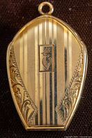Front view showing pinstripe engraving, foliate etching, and monogram "E"