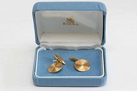 Cufflinks displayed in blue Birks box, lid open