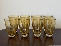 Front view of the set of eight amber bubble glasses