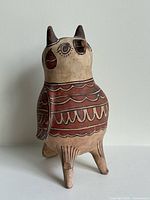 Front three-quarter view of painted pottery bird showing decorative motifs and general form