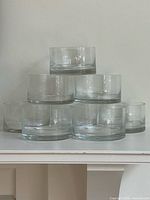 stacked view showing seven of the eight clear glass bowls