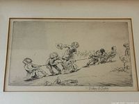close-up of the etching showing children playing tug of war