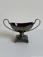 Front view of silver-plated salt dish with cranberry glass liner