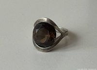 Oblique view showing smoky quartz stone and silver frame