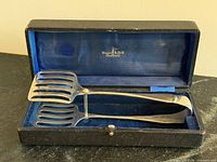 Tongs in open presentation box showing Walker & Hall Sheffield mark