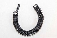 Front view of full bracelet showing rhinestone rows and clasp