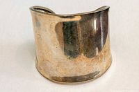 Front view of wide cuff bracelet showing exterior surface and patina