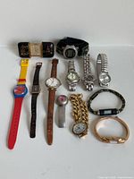 Group shot of Halda travel clock and 11 assorted women’s wristwatches
