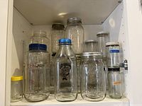 Cabinet shelf displaying all assorted jars and bottles