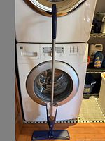 Full view of Bona spray mop showing handle, solution reservoir, and mop head with pad