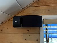Front angle of left Bose 161 speaker mounted on wall
