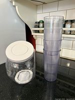 cookie jar and stacked tumblers on countertop