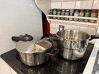 Pressure cooker and steamer pots side by side on countertop