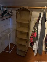 Full view of beige hanging fabric organizer suspended from closet rod