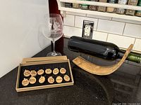 Overview of wine rack balancing bottle, sailboat wine glass, boxed set of charms