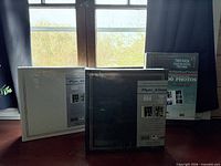 Three sealed packages of photo albums displayed