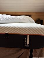 Side view showing Tempur-Pedic ProAdapt Firm label and overall mattress thickness