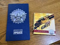 Front view of both items: Police box set and True Grit audiobook
